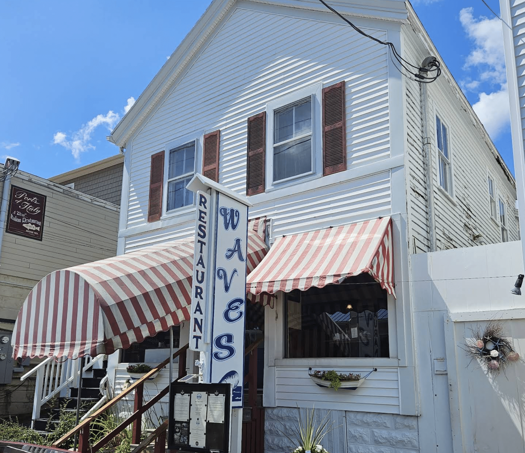 Quaint restaurant with striped awnings.